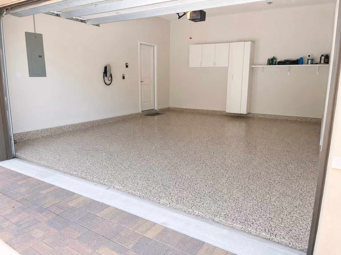 Two-car garage with a light granite flake floor